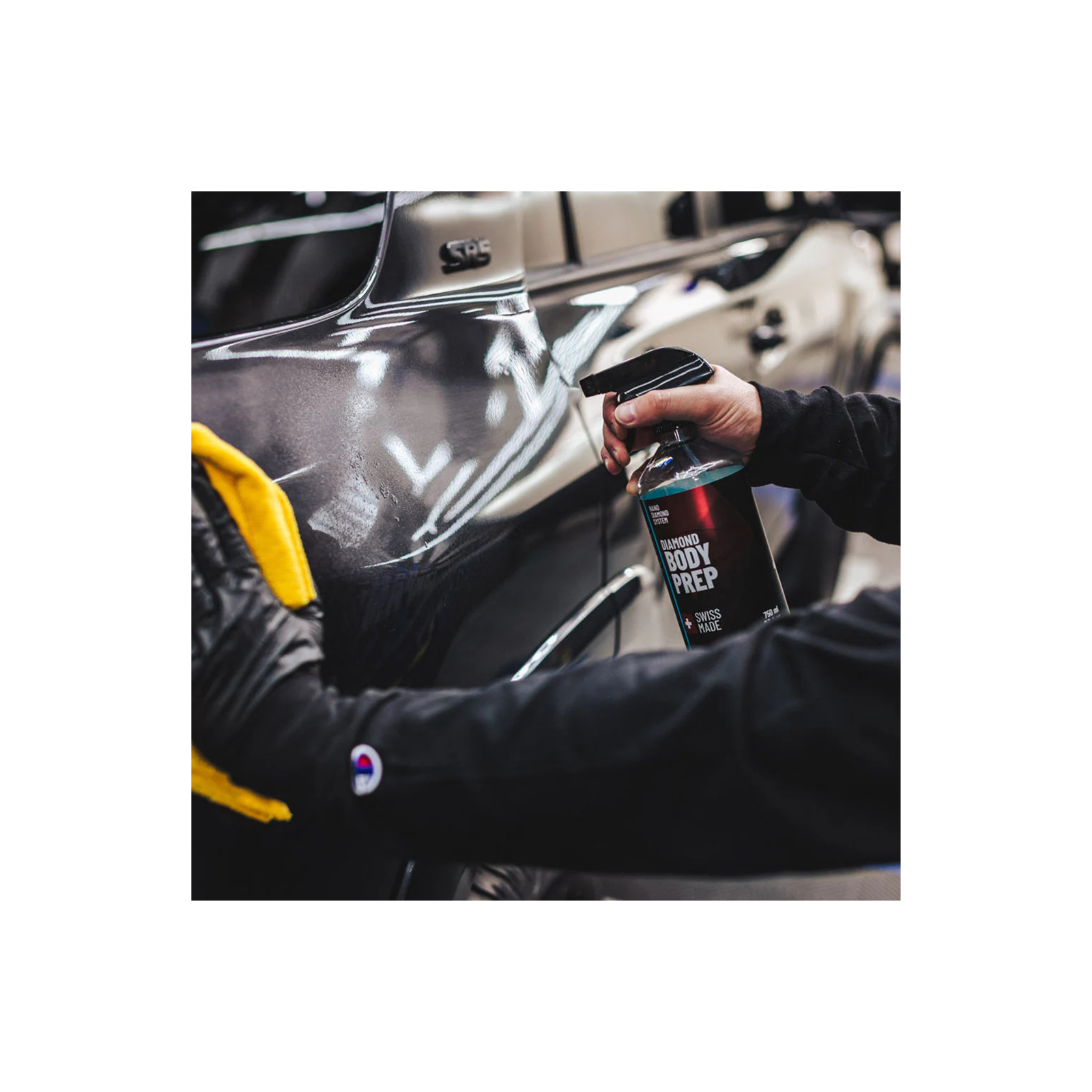 Man spraying Diamond ProTech Diamond Body Prep to prepare car surface for ceramic coating application.