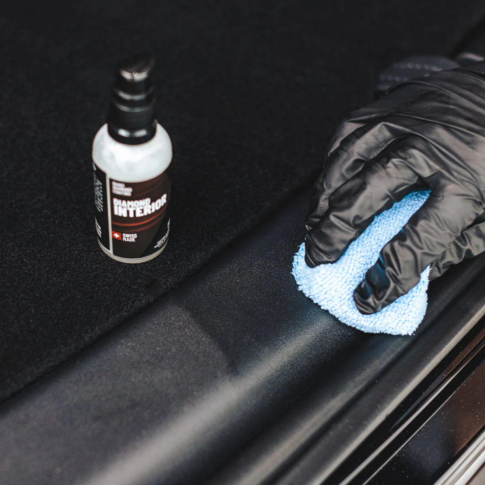 Gloved hand applying Diamond ProTech Diamond Interior to restore and enrich faded trim and surfaces. 