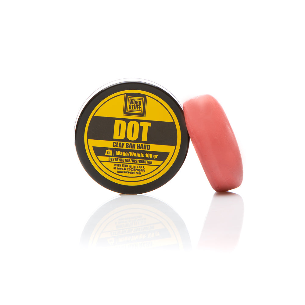 Work Stuff DOT Clay Bar Hard leaning against its product tub, used for heavy-duty contaminant removal in auto detailing.